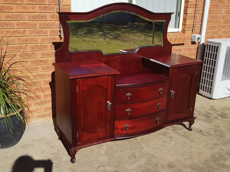 Mahogany antique dresser with drawers and side doors after restoration. 