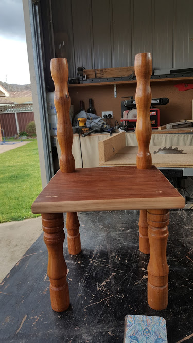 Filling incorrectly drilled holes with wood filler before sanding.