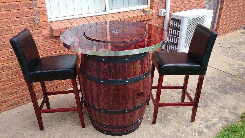 Wine barrel bar table with a hidden wine bucket under the lid with resin surface.  Including 2 bar stools.