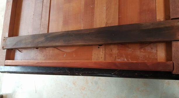 Screwing recycled hardwood support beam into posts