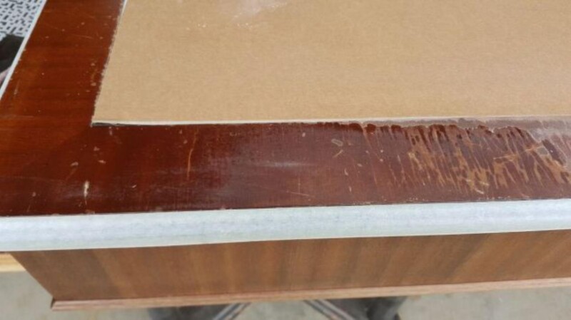 Thick cracked varnish surface on desk top. 