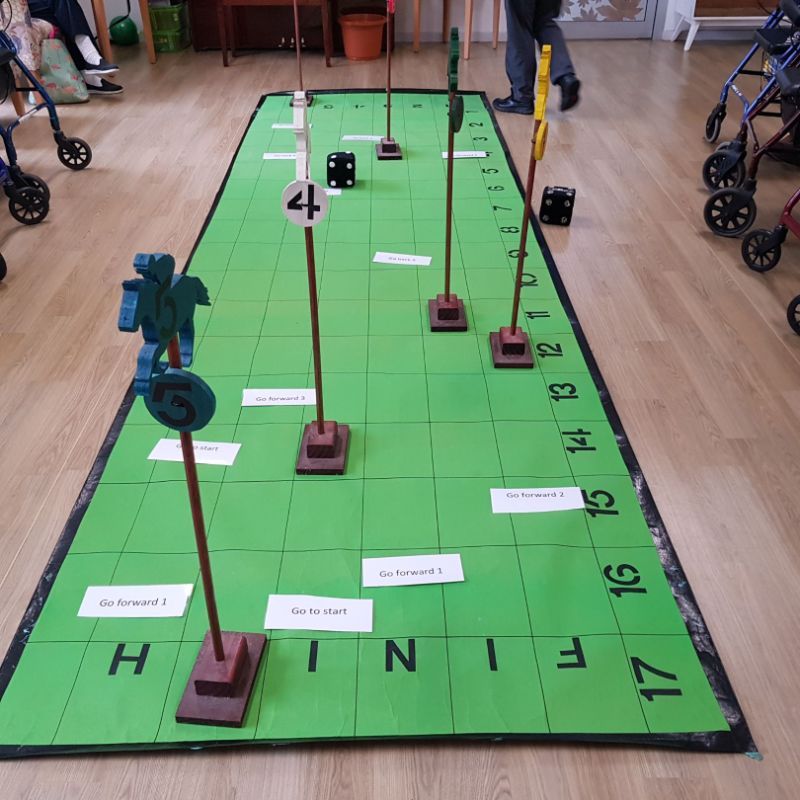 Horse racing game with wooden horses and large race track