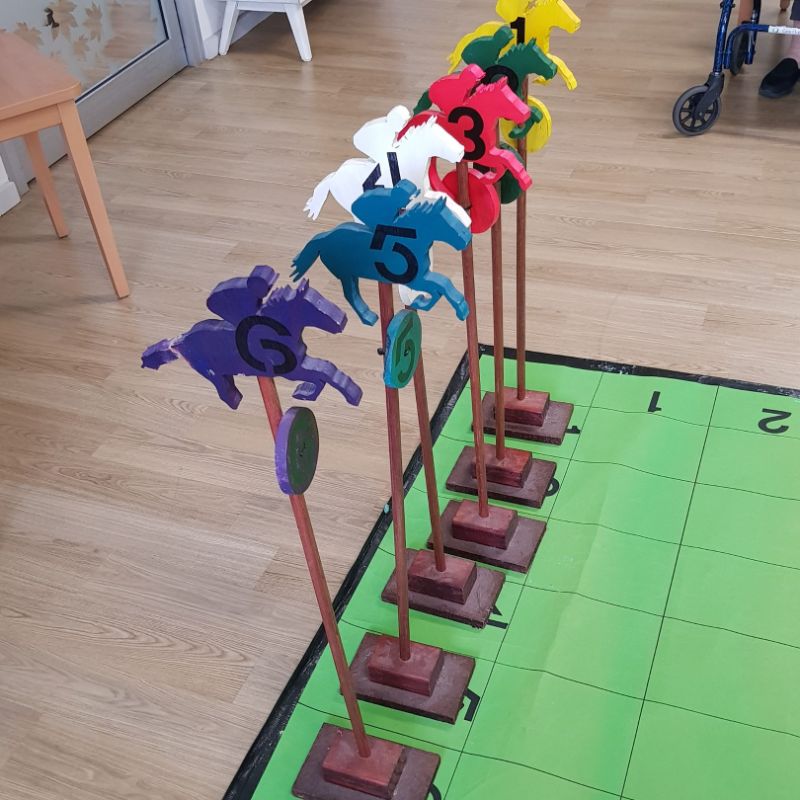 DIY wooden coloured horse with numbers on the numbered floor track. 