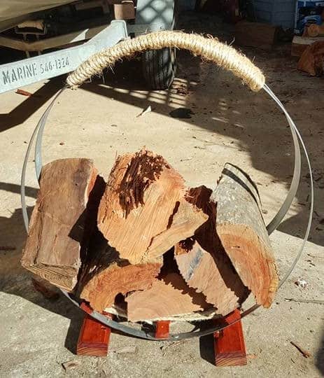 Complete Firewood stand made with wine barrel bands and sisal rope with logs.