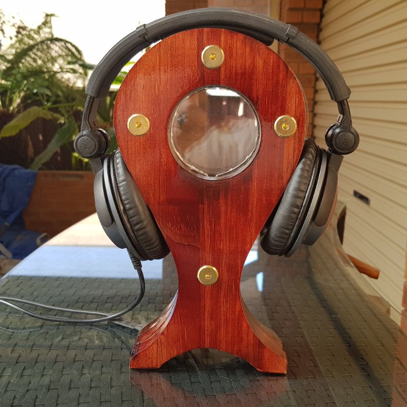 Headphone stand with headphones with Led lights inside.