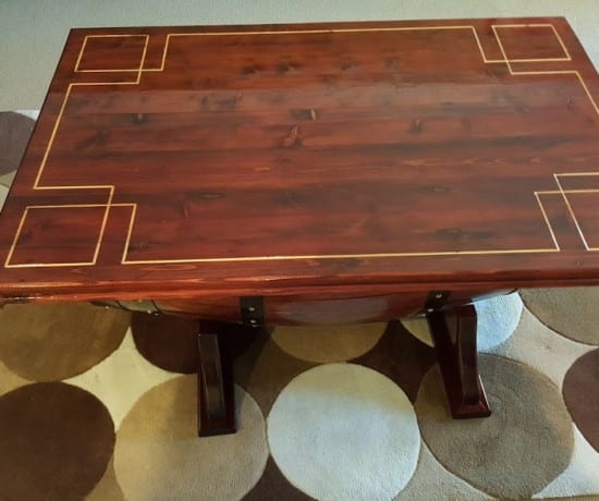 wood table with great key design carved into the surface.