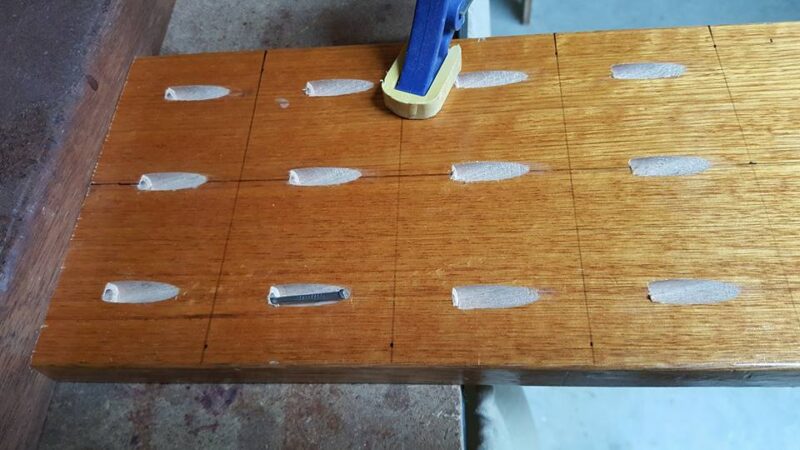 Dart being tested for fit in freshly drilled pocket hole
