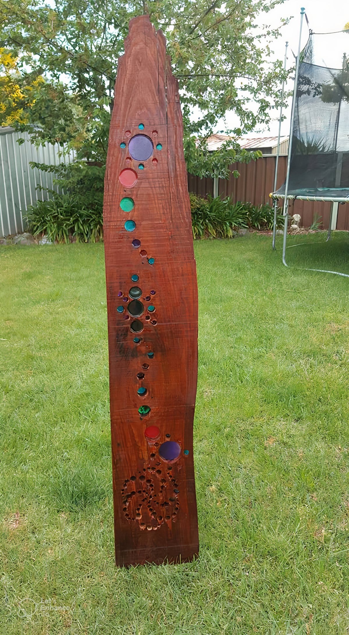 DIY wooden suncatcher with hole cut out and filled with coloured resin.