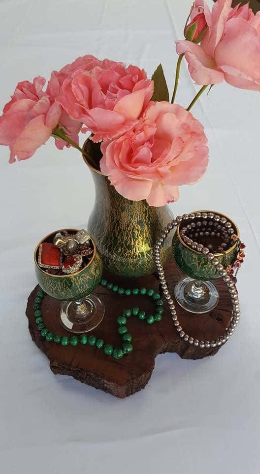 Glass vase and wines glasses with unicorn spit effect used as storage.