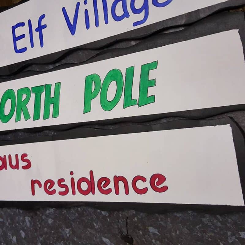 Close up view of small Christmas directional signs.