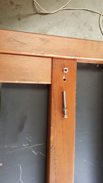 Attaching the headboard to the box with bolts.