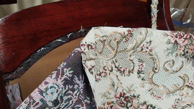 Stapling new patterned fabric onto the chair