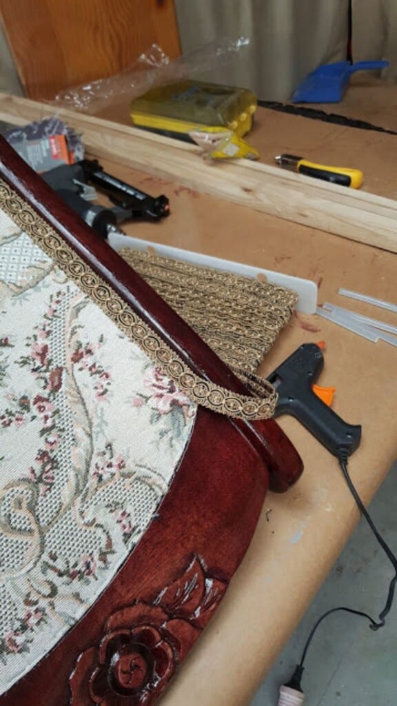 Gluing gold gimp braid over upholstery staples