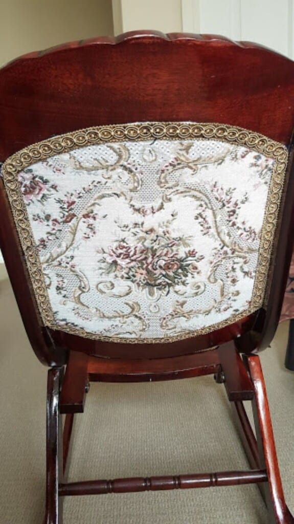 Finished restored rocking chair with rich stain and new fabric - back view