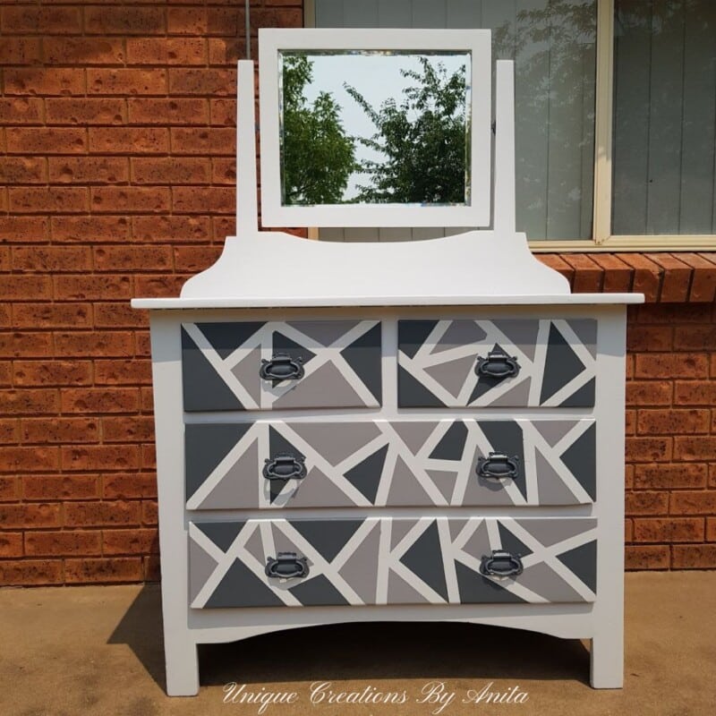 Dresser with mirror painted with chalk paint in a geometric design. 