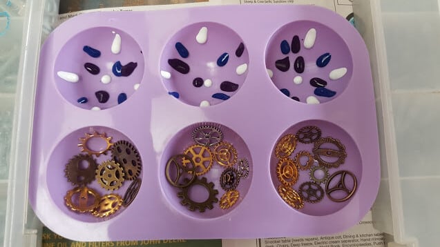 Close-up of charms arranged inside silicone mould
