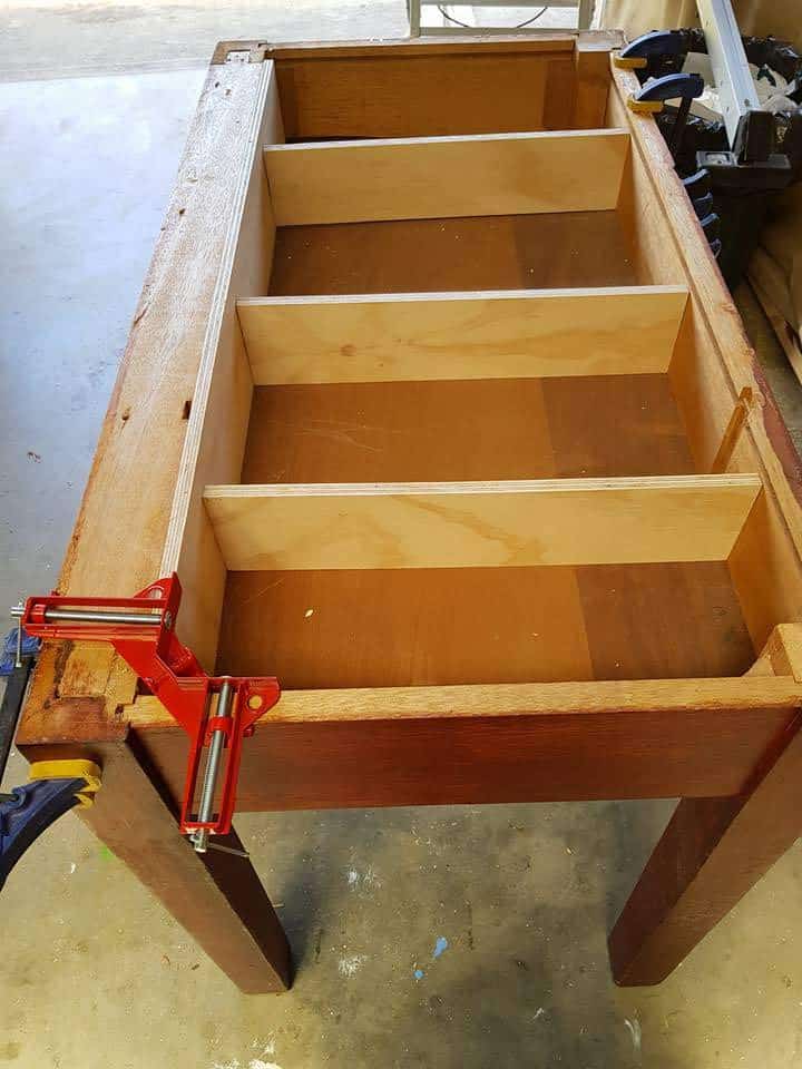 Plywood partitions installed inside table with rounded corners