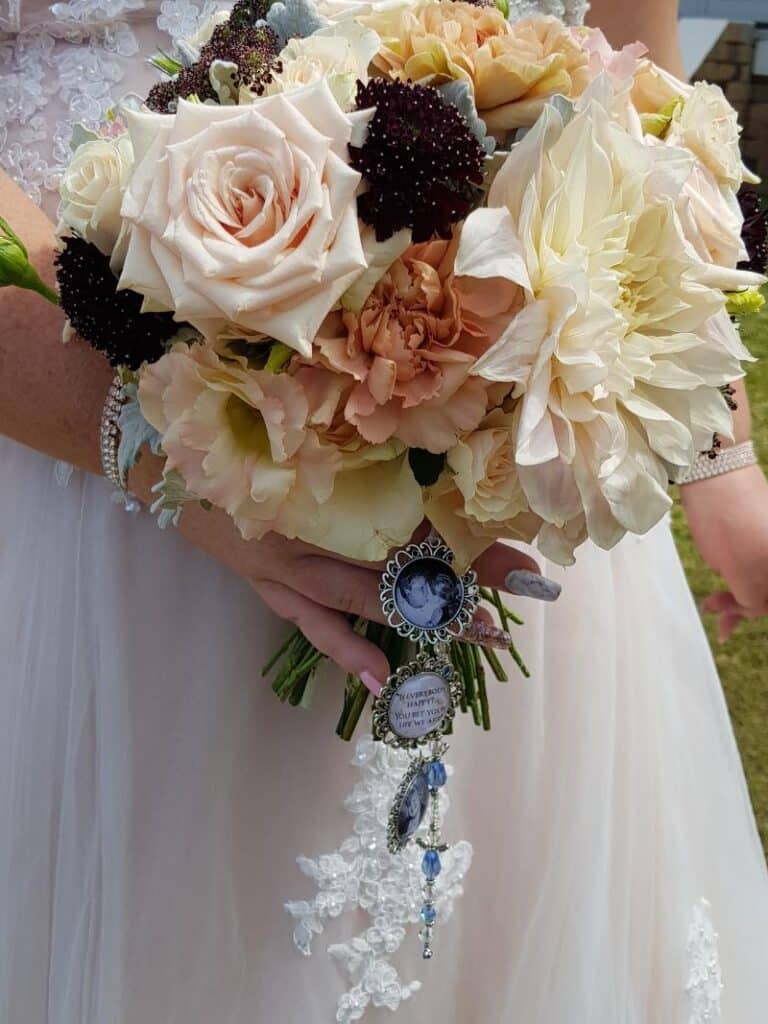 Bridal bouquet with photo charms dangling down. 