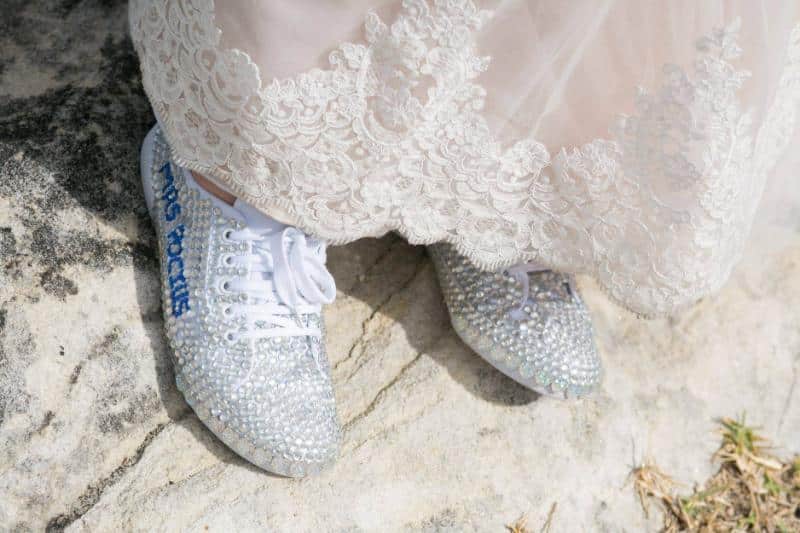 Full view of finished handmade bridal sneakers on wooden floor