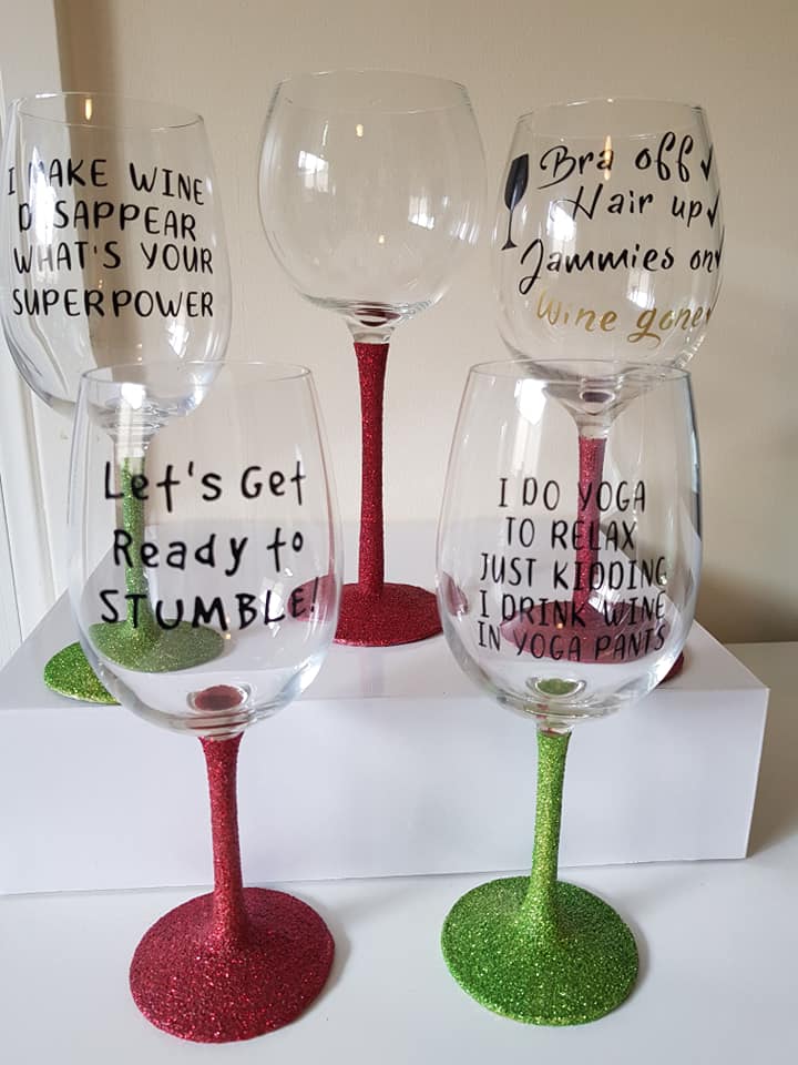 Finished glitter wine glass with vinyl quotes made with a Cricut- display