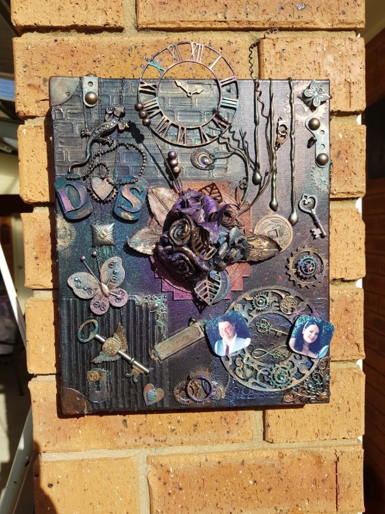 Mixed media art canvas with wedding mementoes.