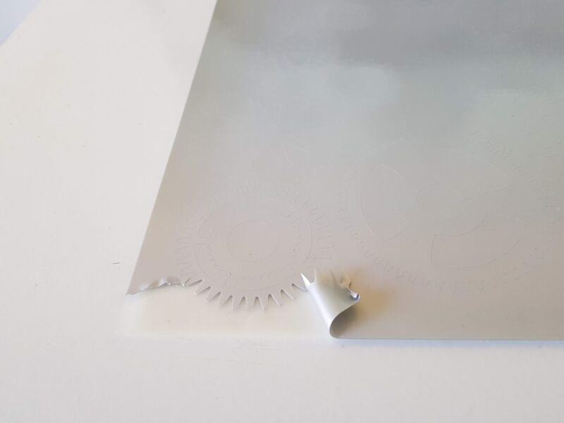 Removing excess vinyl from steampunk design on cutting mat