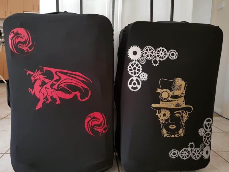 Custom suitcase with steampunk and dragon vinyl design made using Cricut and HTV”