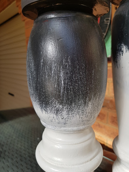 Close-up of white chalk paint applied over black using a dry brush technique.