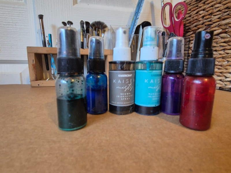 Homemade shimmer sprays in travel spray bottles. 