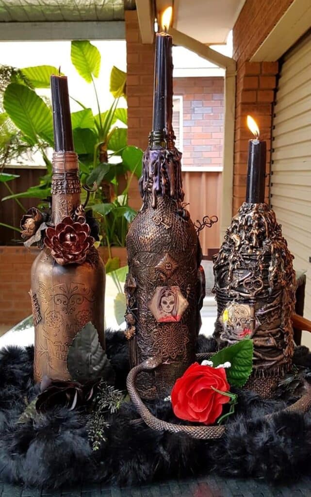 Spooky Mixed Media Art Halloween Bottles outside on a bar