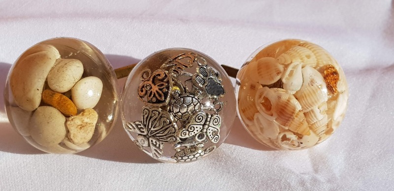 DIY resin knob with natural sea shells for coastal or beach-themed furniture.

