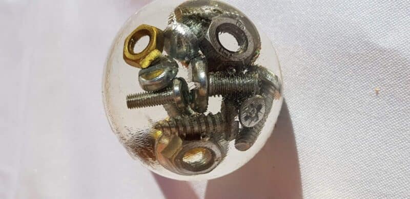 Resin door knob featuring embedded nuts and bolts, ideal for workshop décor.