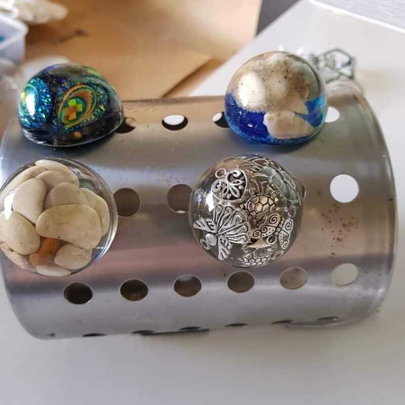 Resin door knobs resting in holes for support while polyurethane dries.