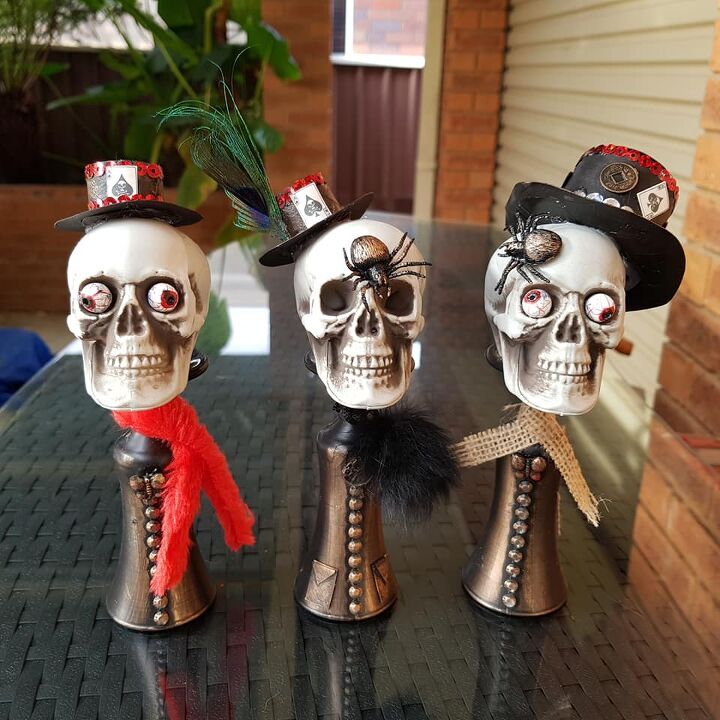 Finished Halloween skull figures wearing mini top hats and scarves