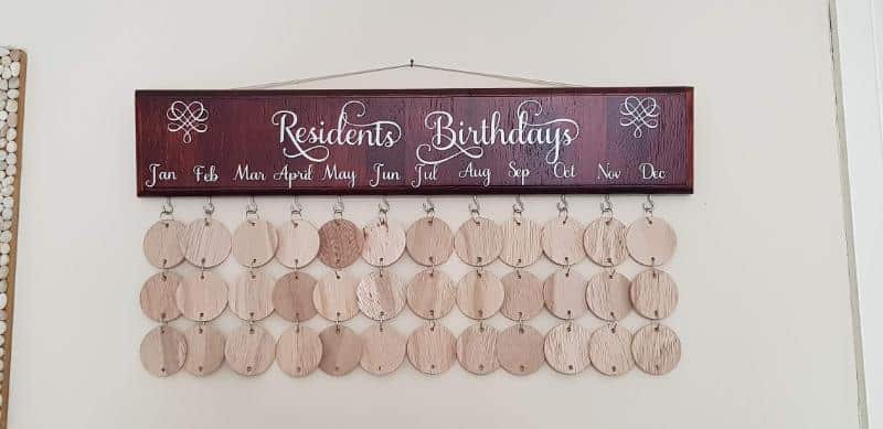 Finished rustic wall calendar with names and birth dates hanging on the wall