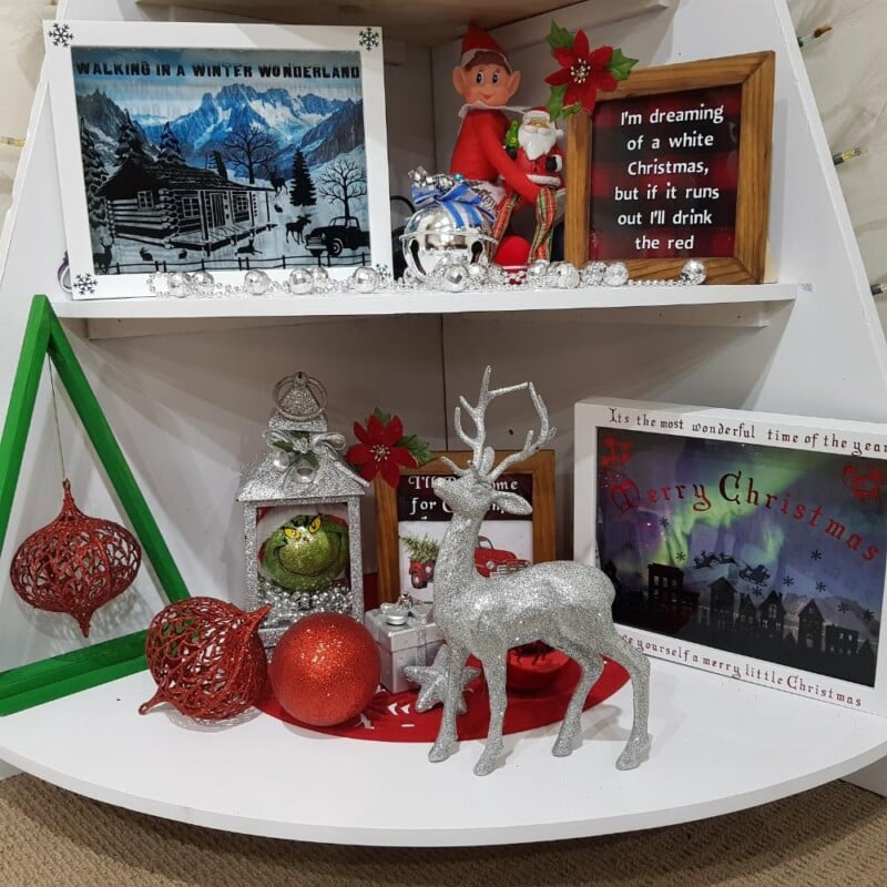 Framed Christmas signs on the lower shelves