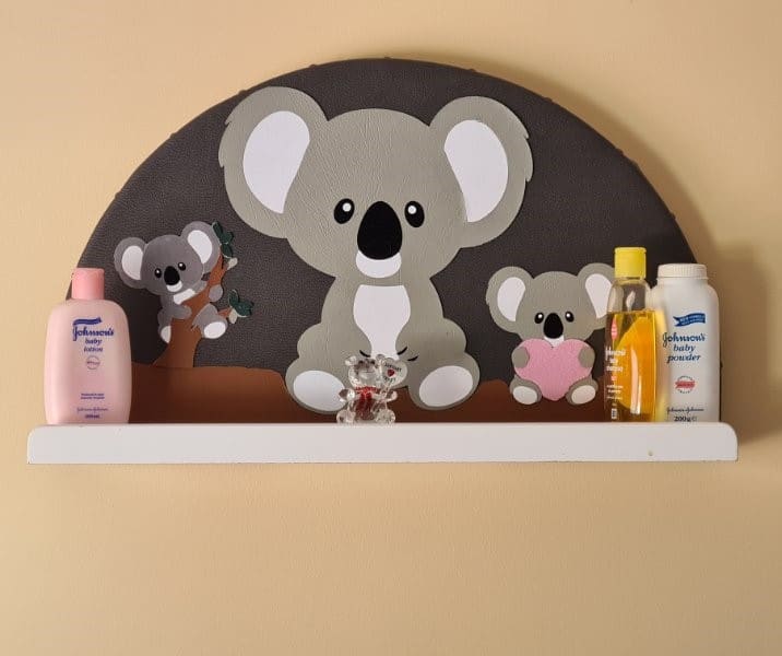 Finished koala nursery shelf styled with baby items