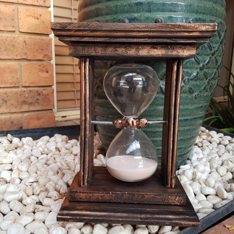 Egyptian‑Themed Sand Timer Stand in garden