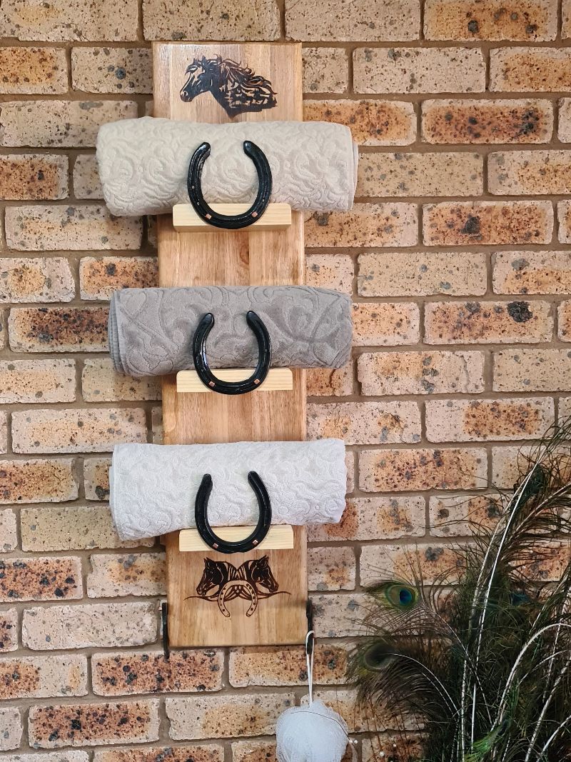 Repurpose old horse shoes into a towel rack.