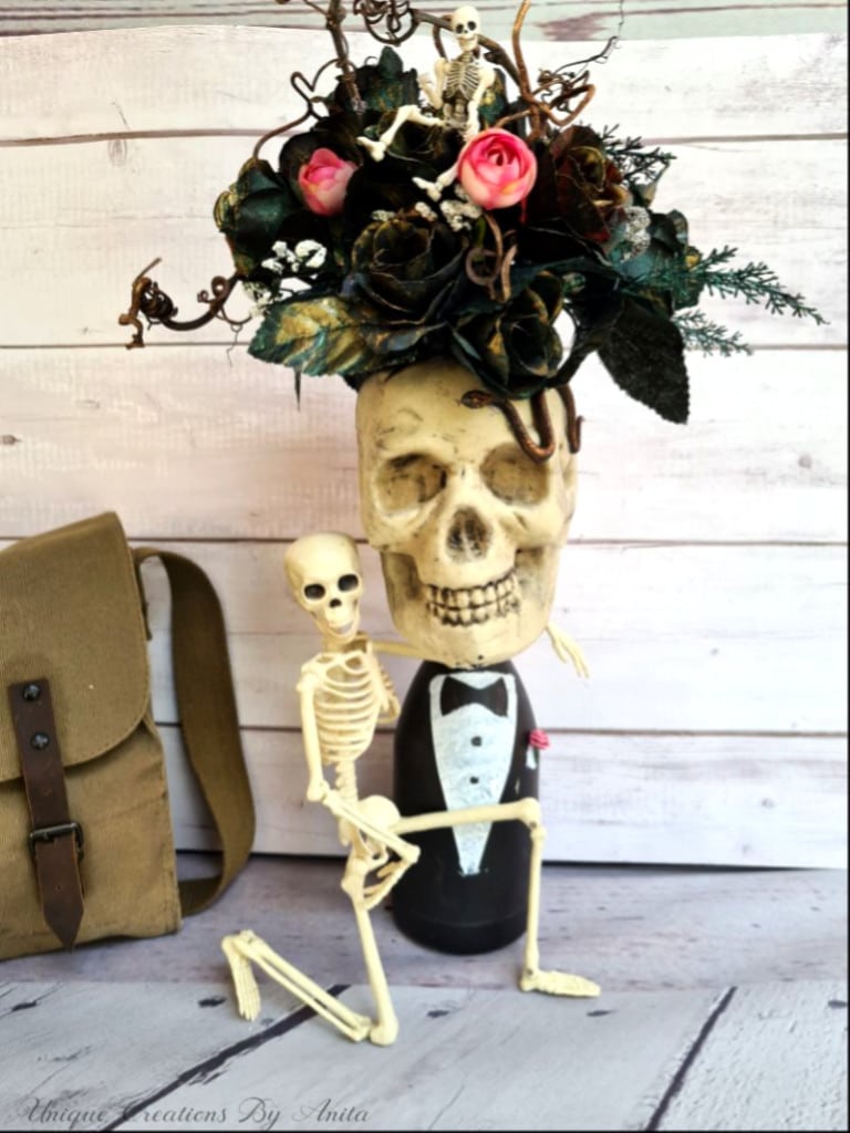 Halloween table centre piece made from a recycle bottle, skull and artificial flower. 