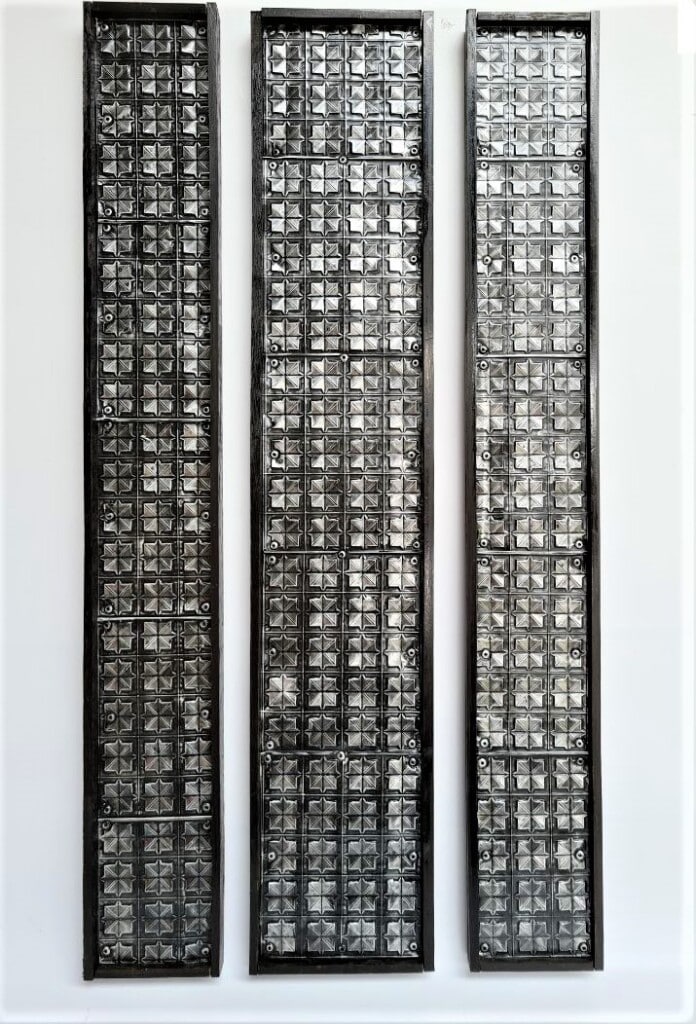 Completed silver aluminium can wall hanging displayed on the wall.