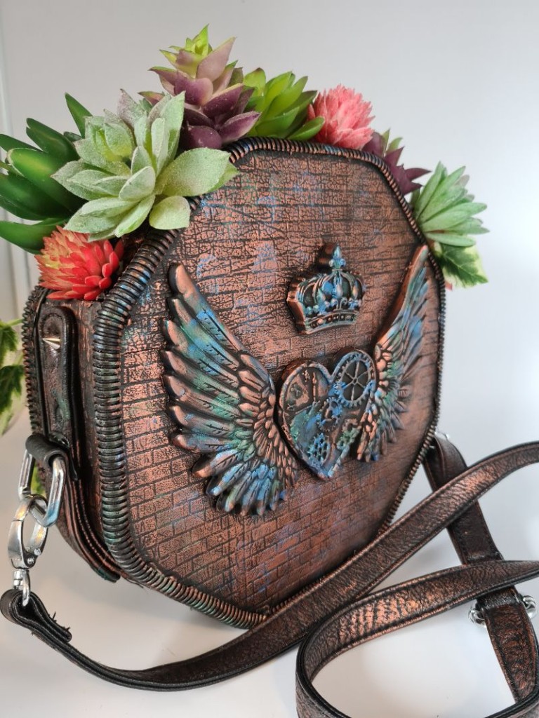 close up view of back of handbags succulent planter