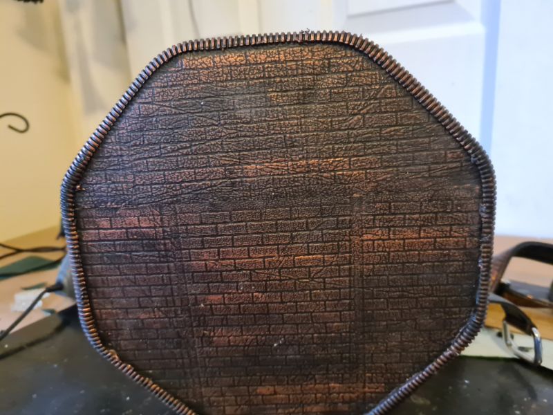 Copper wax rubbed on raised textures to highlight details- back