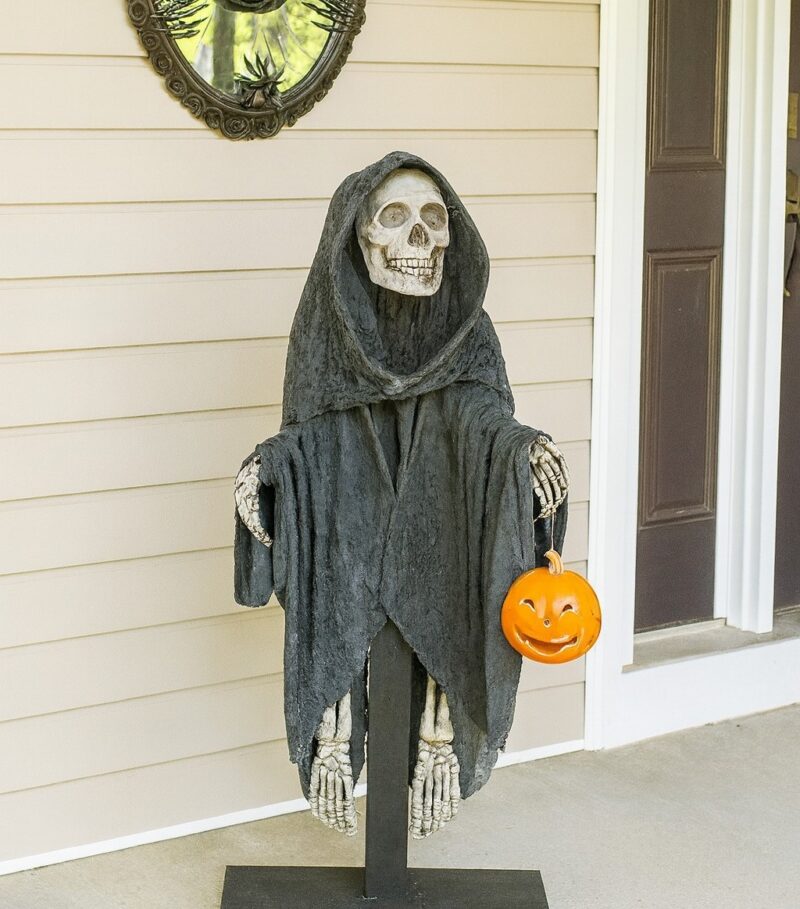 Finished cement grim reaper on the porch
