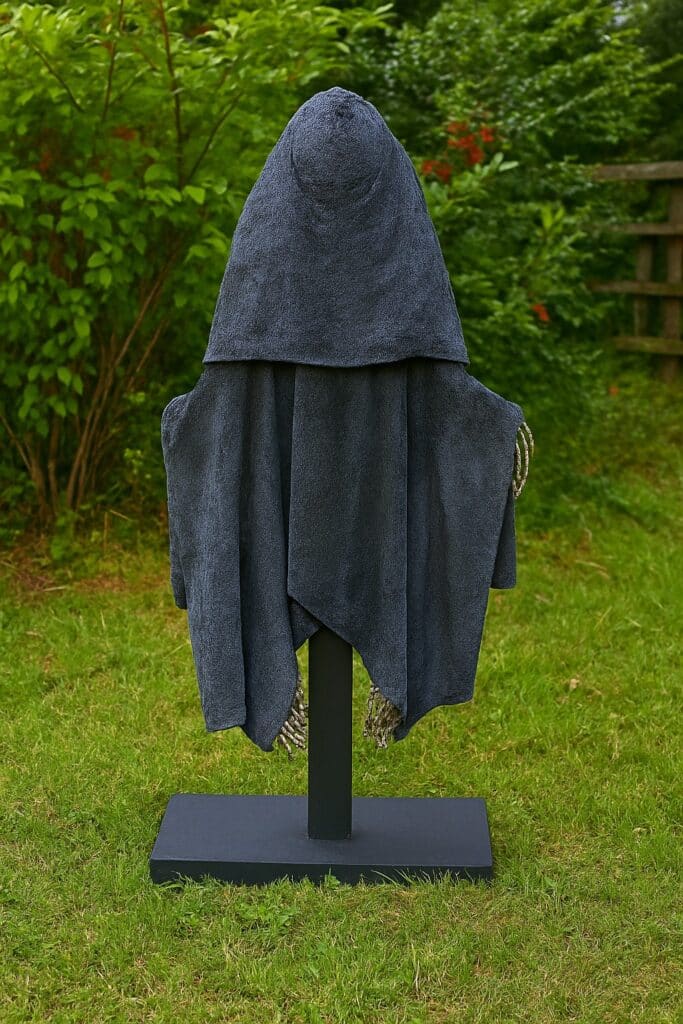 back view of cement grim reaper