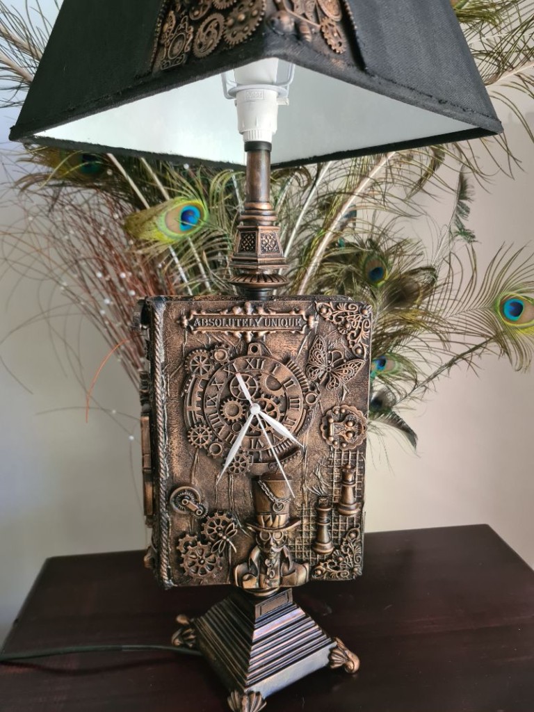 Finished steampunk book lamp styled on side table
