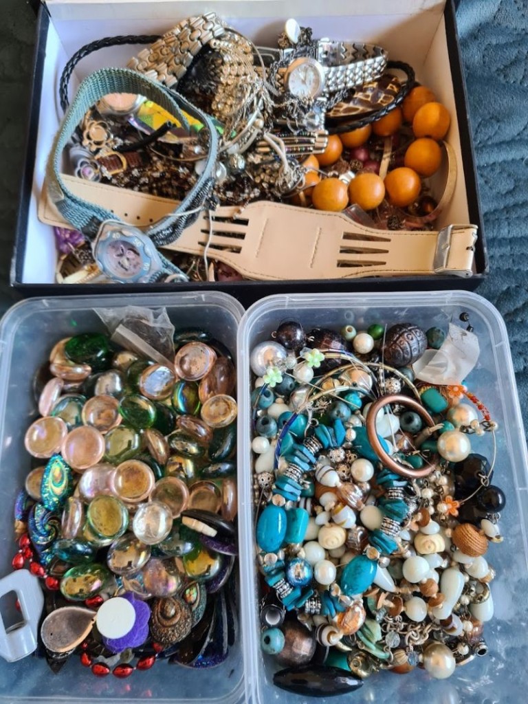 Pile of broken jewellery—chains, bracelets and watches—sourced from an op shop.
