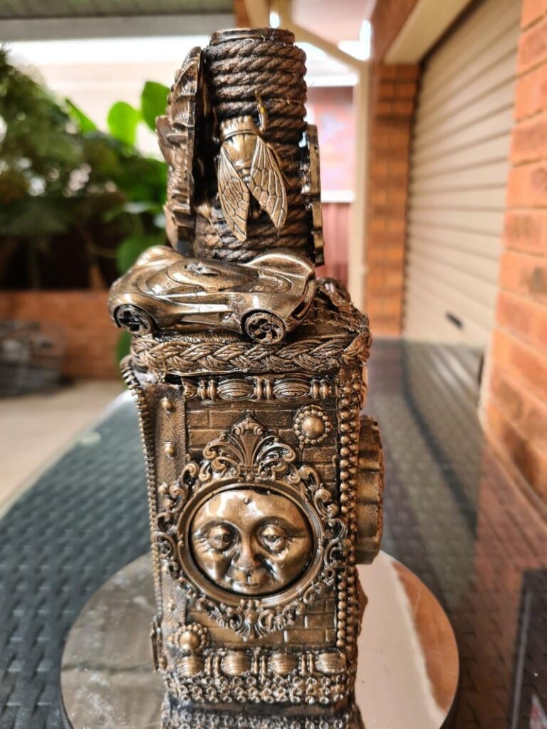 Toy car and insect integrated into bottle design for playful detail.