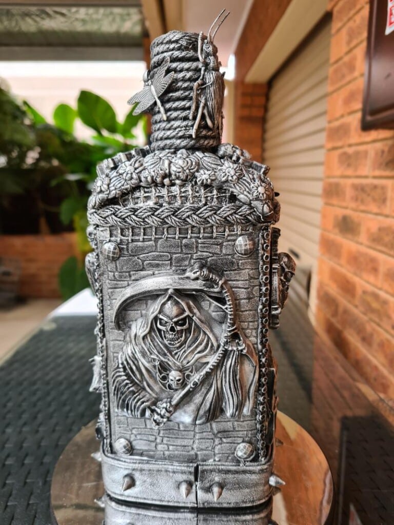 Toy insect integrated into bottle design