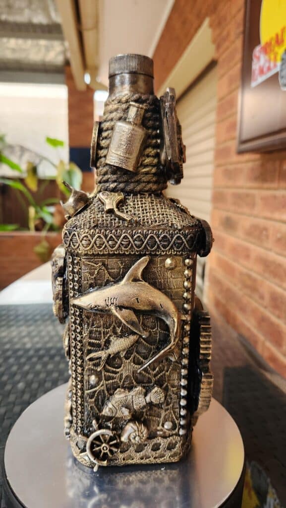 Braids, beads and chains used on bottle art